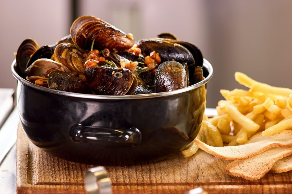 Closeup mussels in saucepan.