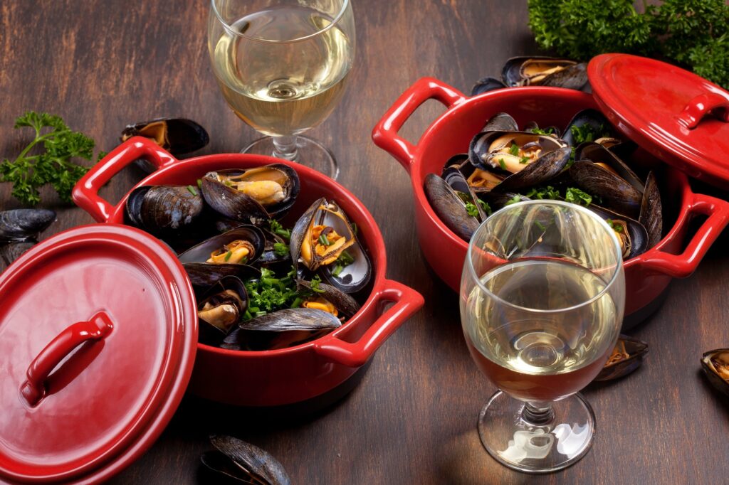 Dinner with mussels in herbs and white wine
